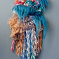 a view of the trollfall mini wall hanging showcasing the fiber waterfalls and the loops in all their glory!