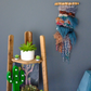 the trollfall mini wall hanging displayed near some desert inspired home decor